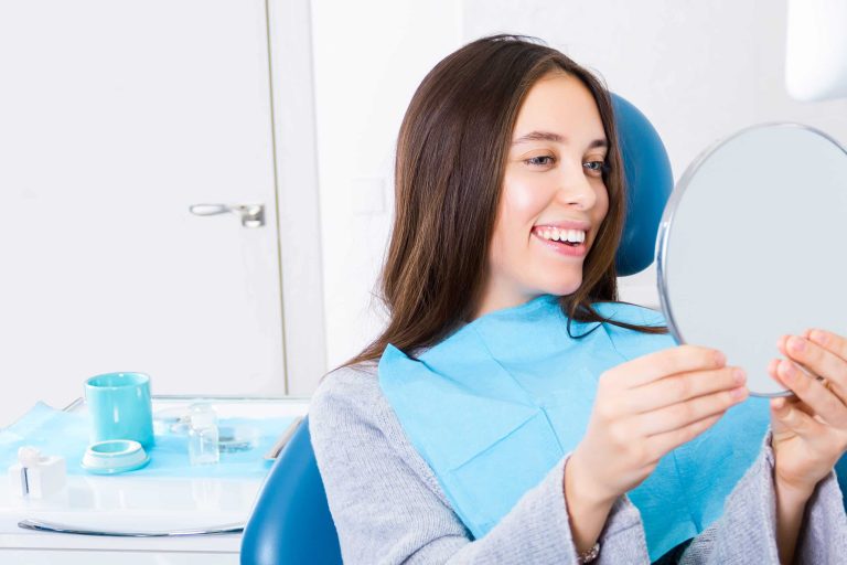 Woman smiling after dental surgery